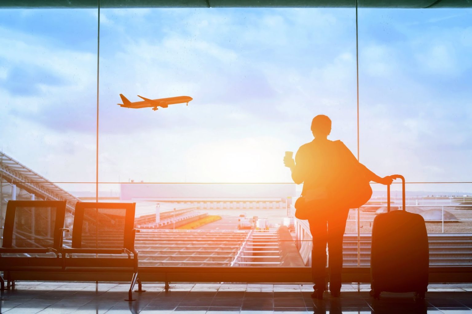 A woman with luggage possibly waiting for her flight