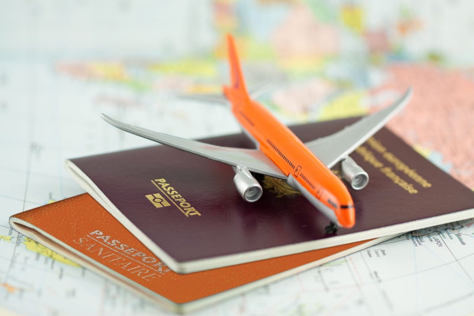 Passport and airplane on a map. 