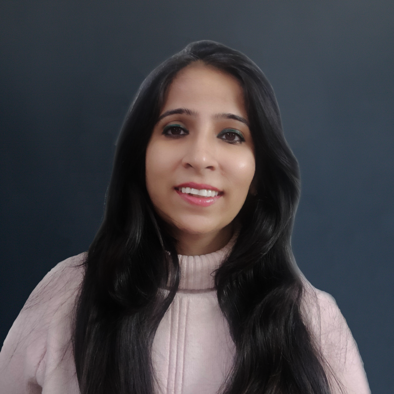 Komal Mehta, a Senior Case Manager, depicted as a woman with long black hair and dressed in a pink sweater.