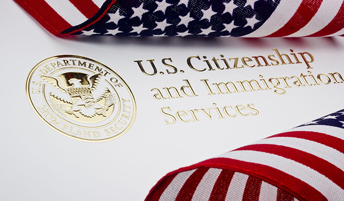 Official emblem of US Citizenship and Immigration Services featuring details on visa consultation and EB-1A Visa.