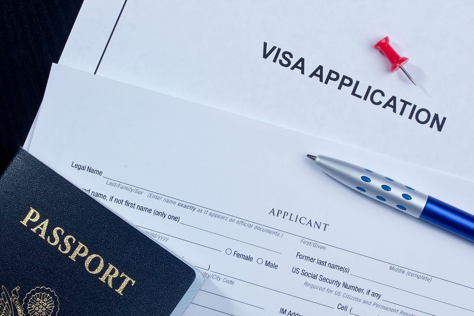 A visa application form alongside a passport, symbolizing the process for E-2 visa eligibility for individual investors.