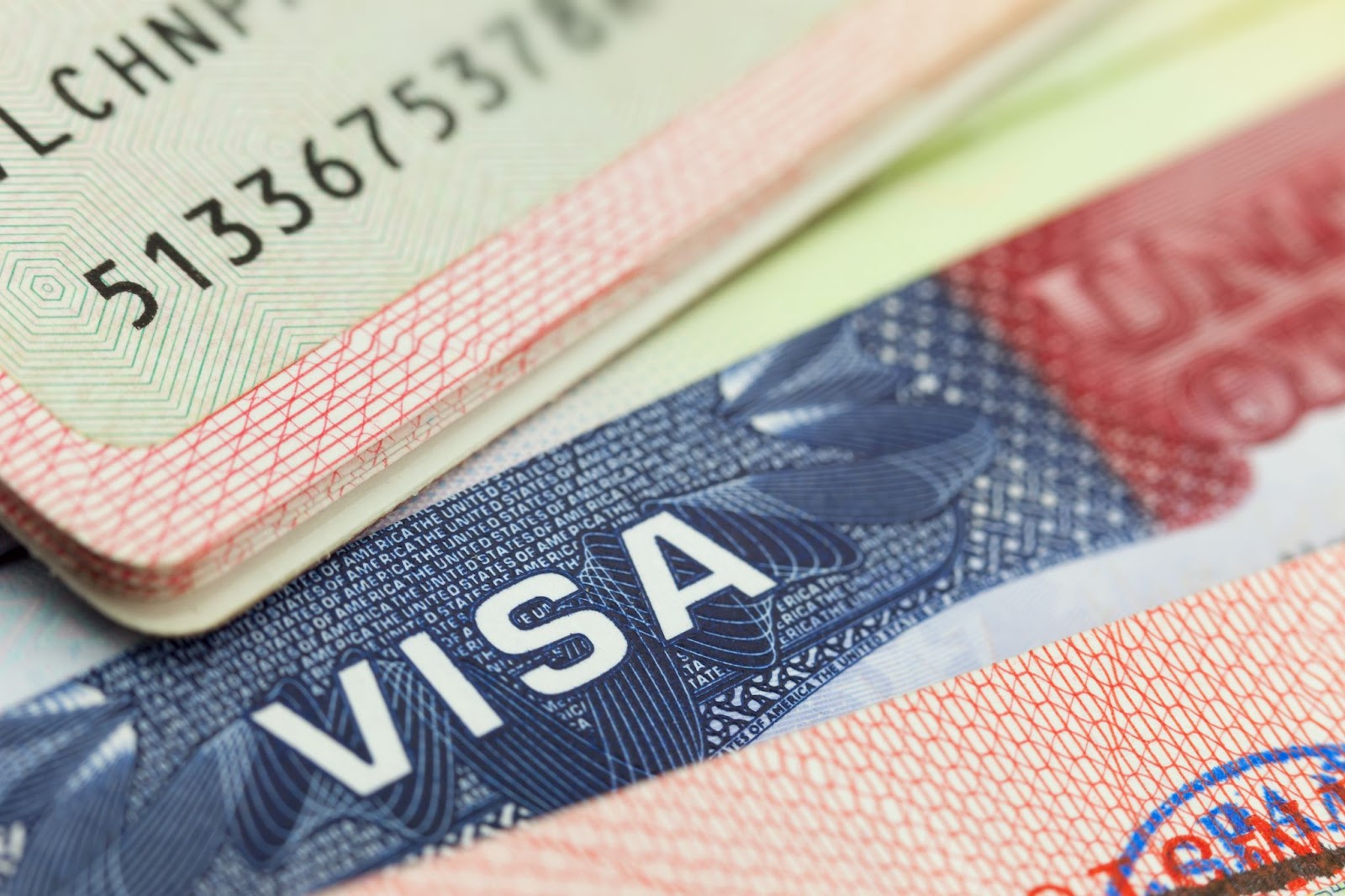 An E-2 visa and passport displayed together, symbolizing the journey of individual investors meeting nationality criteria.