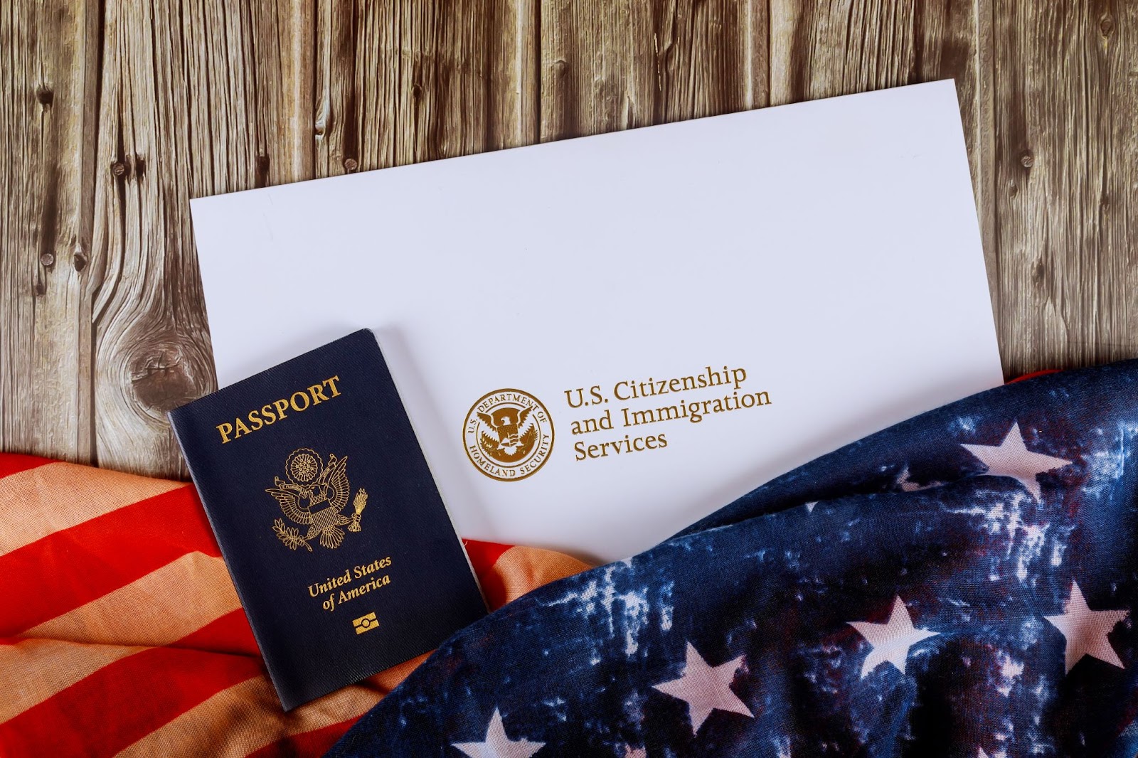 U.S. Citizenship and Immigration Services passport alongside an American flag, symbolizing the journey to U.S. citizenship.